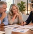 Retired couple reviewing retirement withdrawal charts and market scenarios with a financial educator
